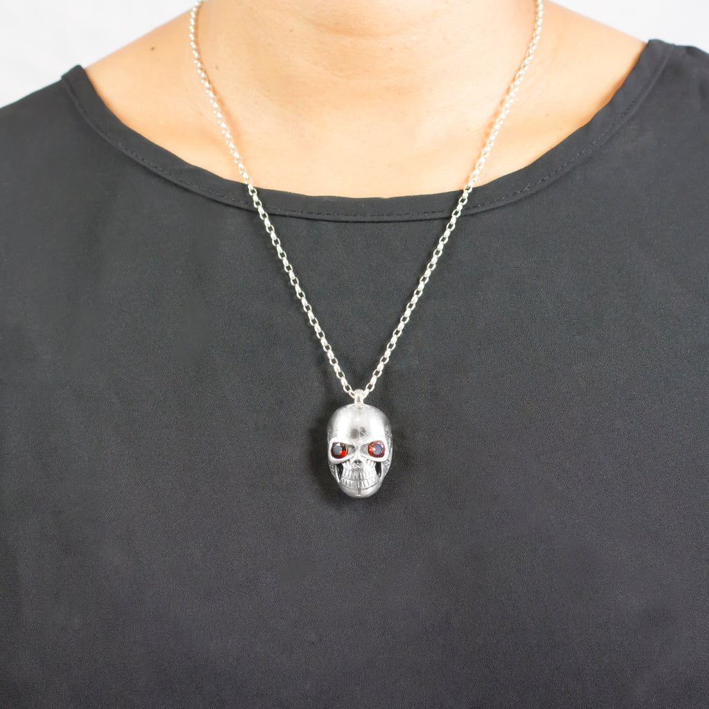 Model Wearing Skull Necklace with red Garnet gemstone for eyes Garnet Necklace made in earth