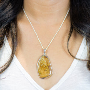 ORGANIC CABOCHON STERLING SILVER AMBER NECKLACE WITH INSECT INSIDE ON MODEL