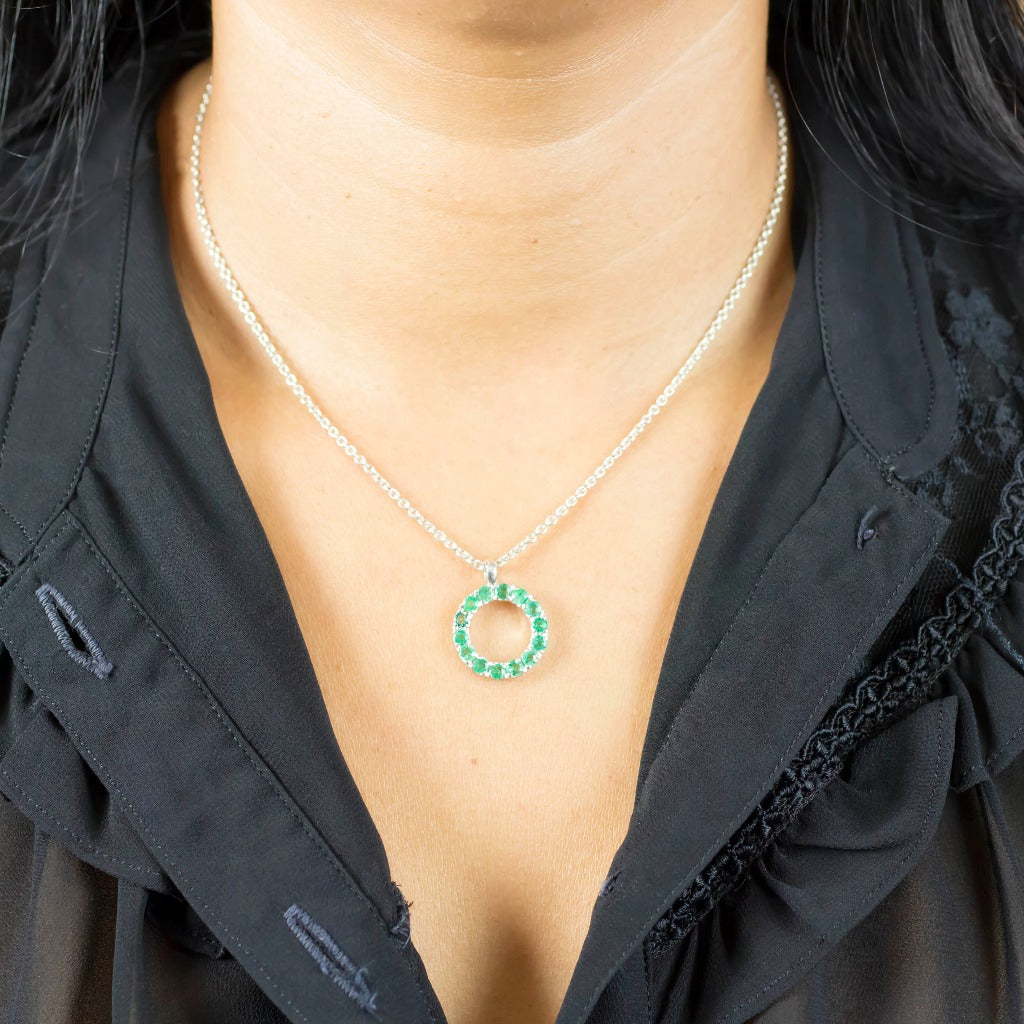 Model wearing Bright green set in a silver Emerald Necklace made in earth