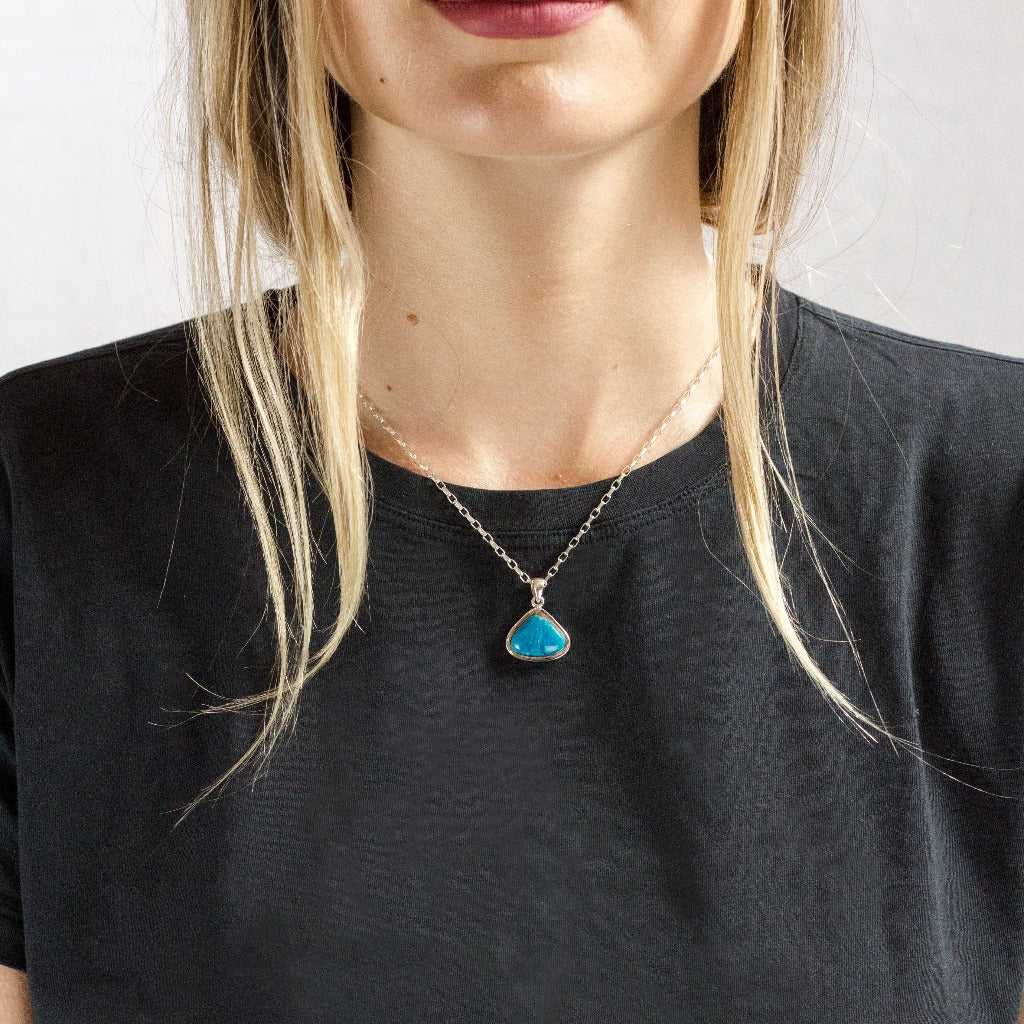Model wearing Bright Blue textured Cavansite necklace made in earth