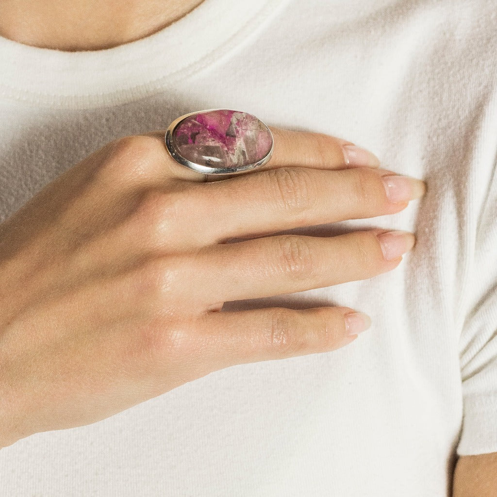 Model Wearing Pink Oval Cabochon Cobaltian Calcite Ring In Sterling Silver