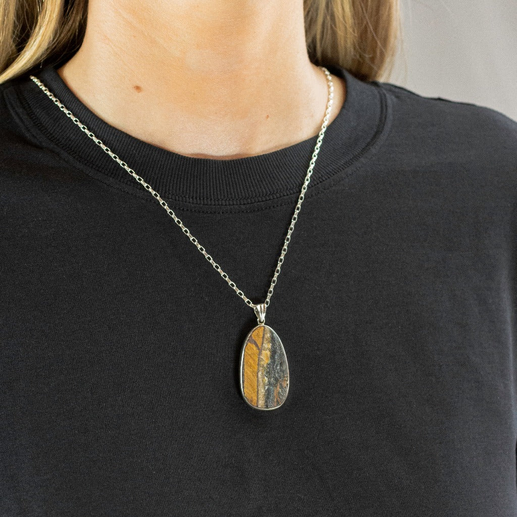 Gold and Brown raw teardrop Hawks Eye Necklace on model