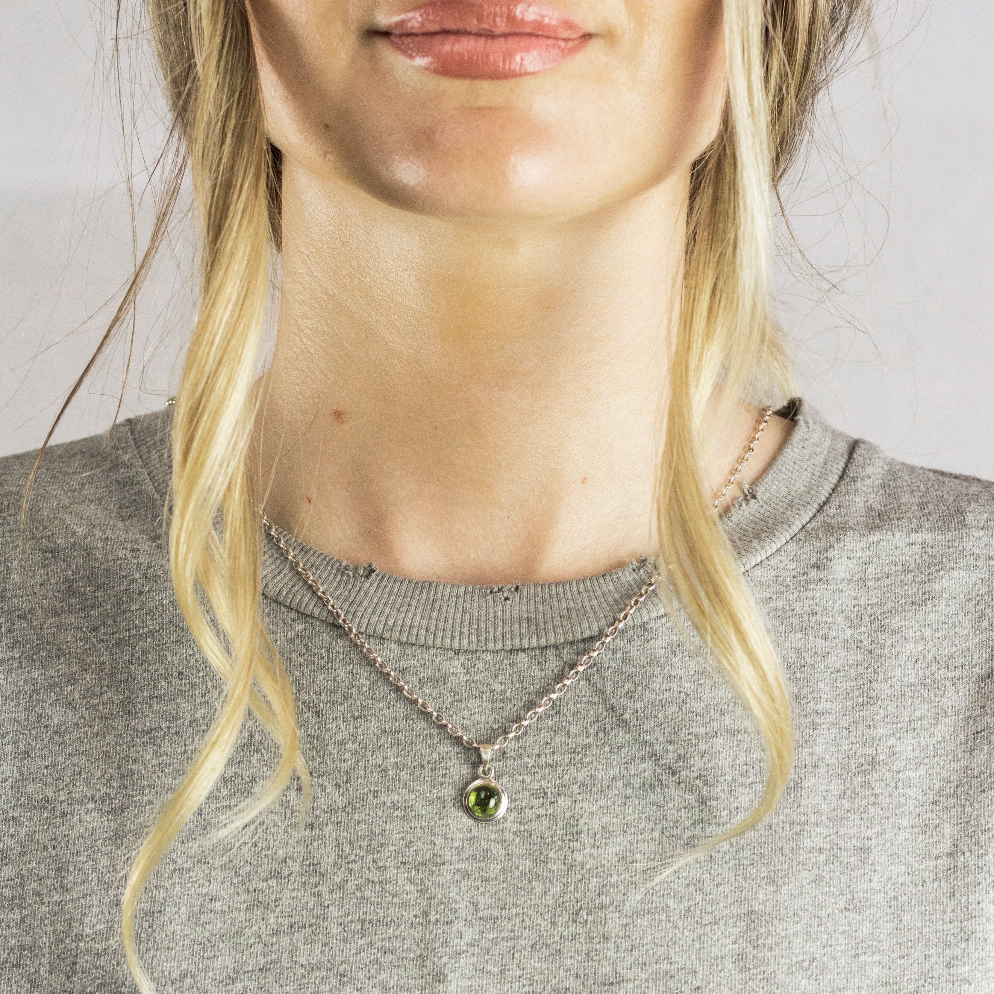 Model Wearing Peridot round cabochon necklace made in earth