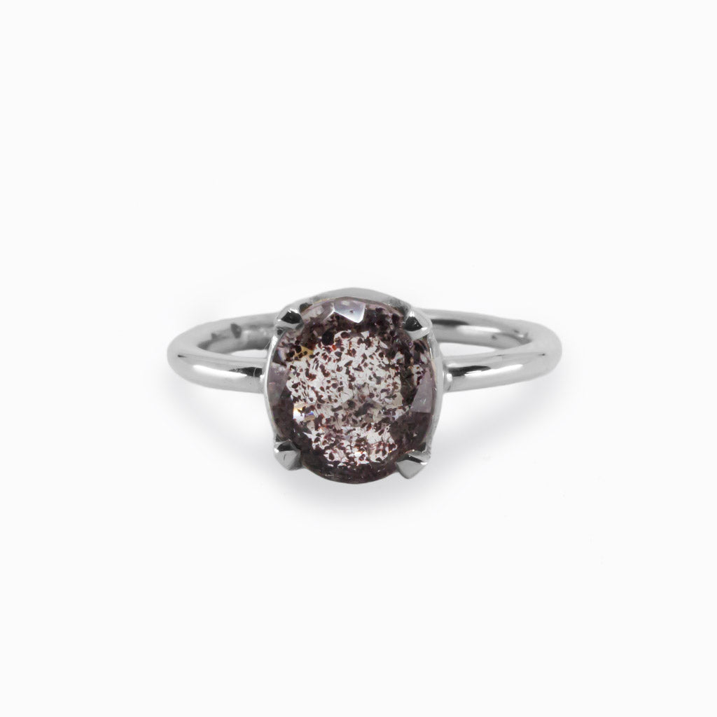 lepidocrocite ring A Clear gemstone with a dark red brown border and dark brown specks Made in Earth